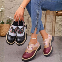 Rosette oxfords in burgundy held in hand