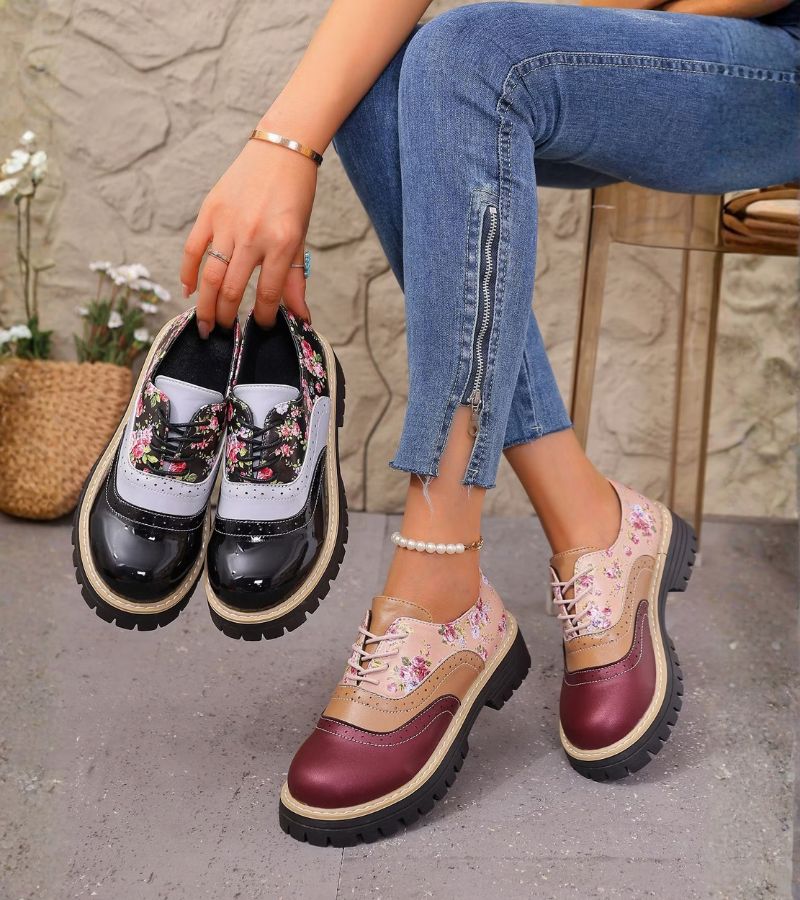 Rosette oxfords in burgundy held in hand