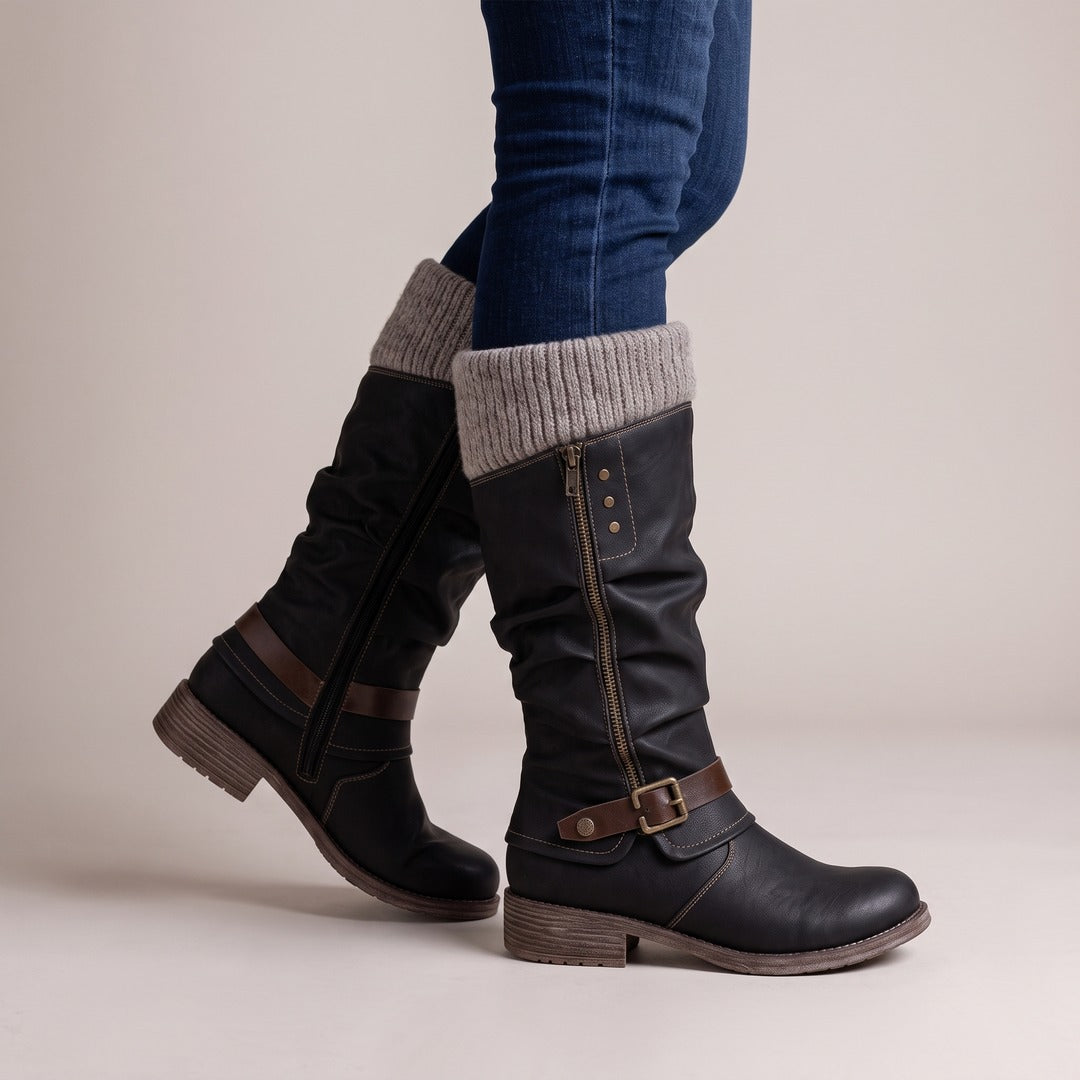 Greta boots in black, side view worn with jeans