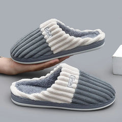 Paula slippers in gray, held in a hand