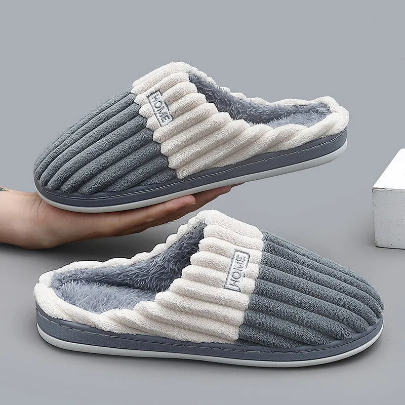 Paula slippers in gray, held in a hand