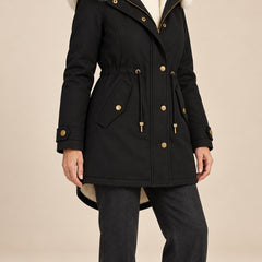 Arvelle winter coat in black, worn with gray pants