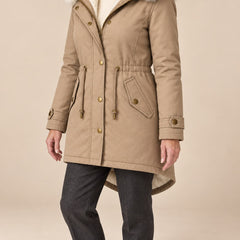 Arvelle winter coat in beige, worn with gray pants