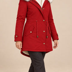 Arvelle winter coat in red, worn with gray pants