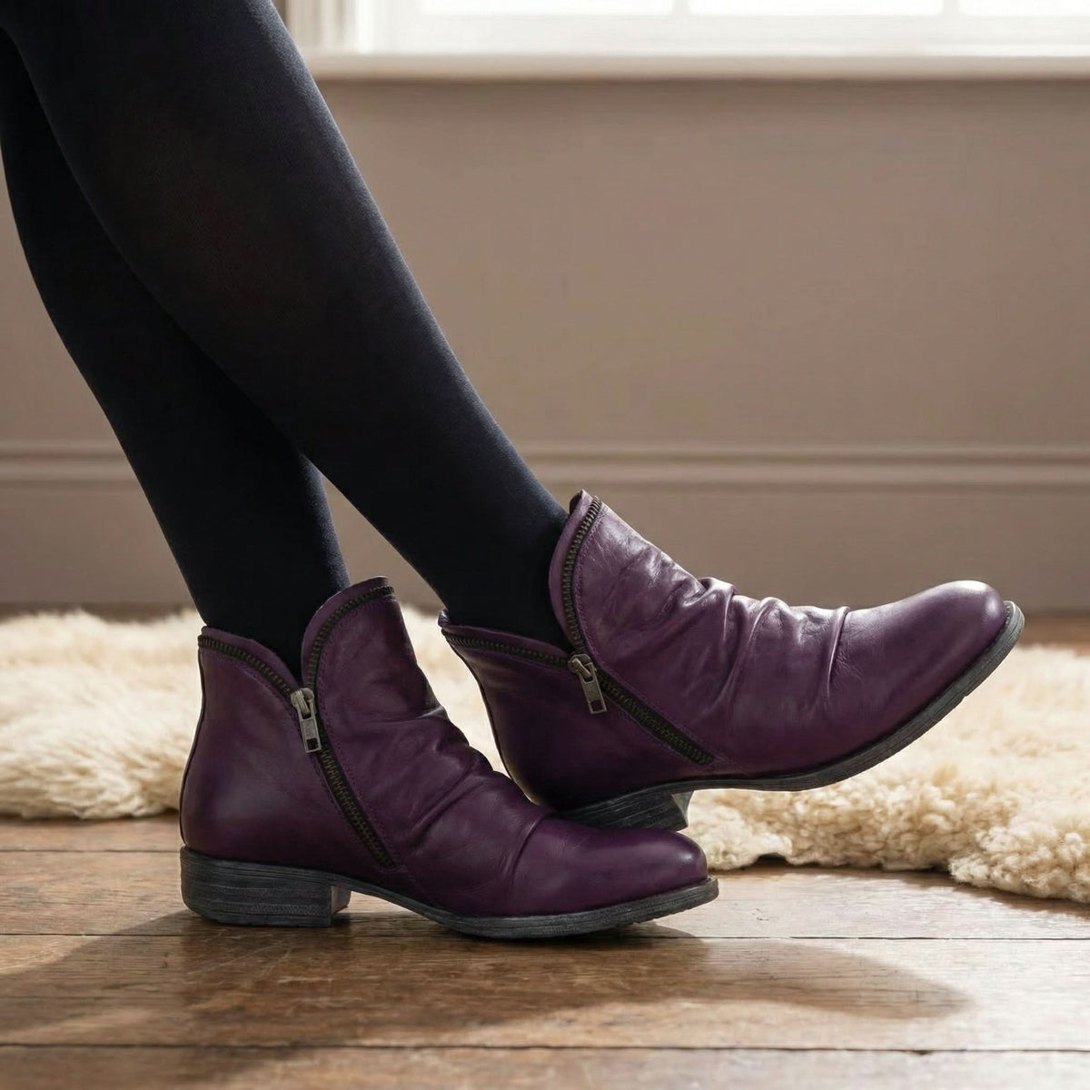 Suzanne ankle boots in purple, worn with black tights