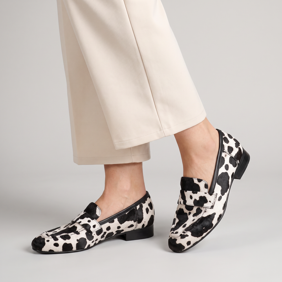 Darcy cow print penny loafers worn