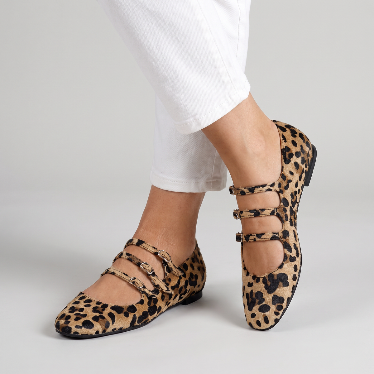 Angelie leopard flats with three buckle straps worn