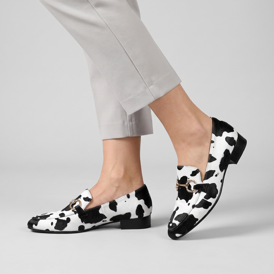 Novie cow print loafers with metal bit worn