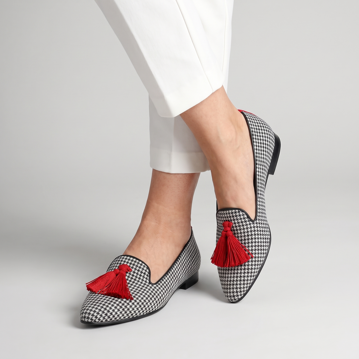 Sasha houndstooth flats with tassel worn