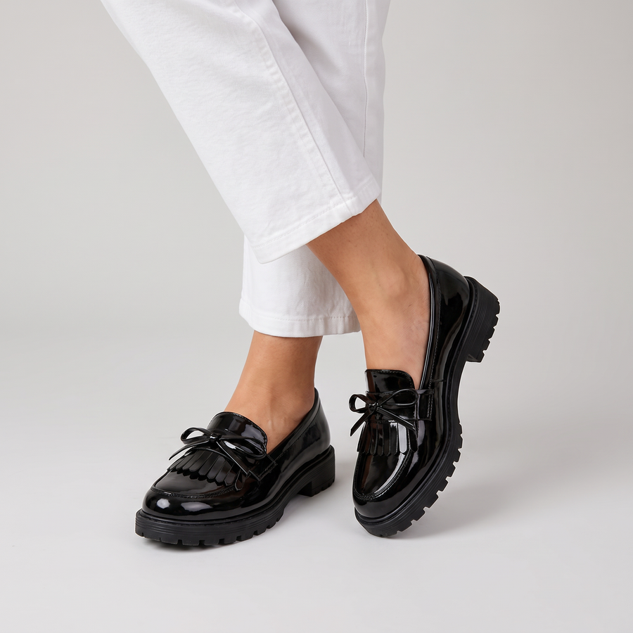 Cailie glossy lug sole loafers with fringe and bow worn
