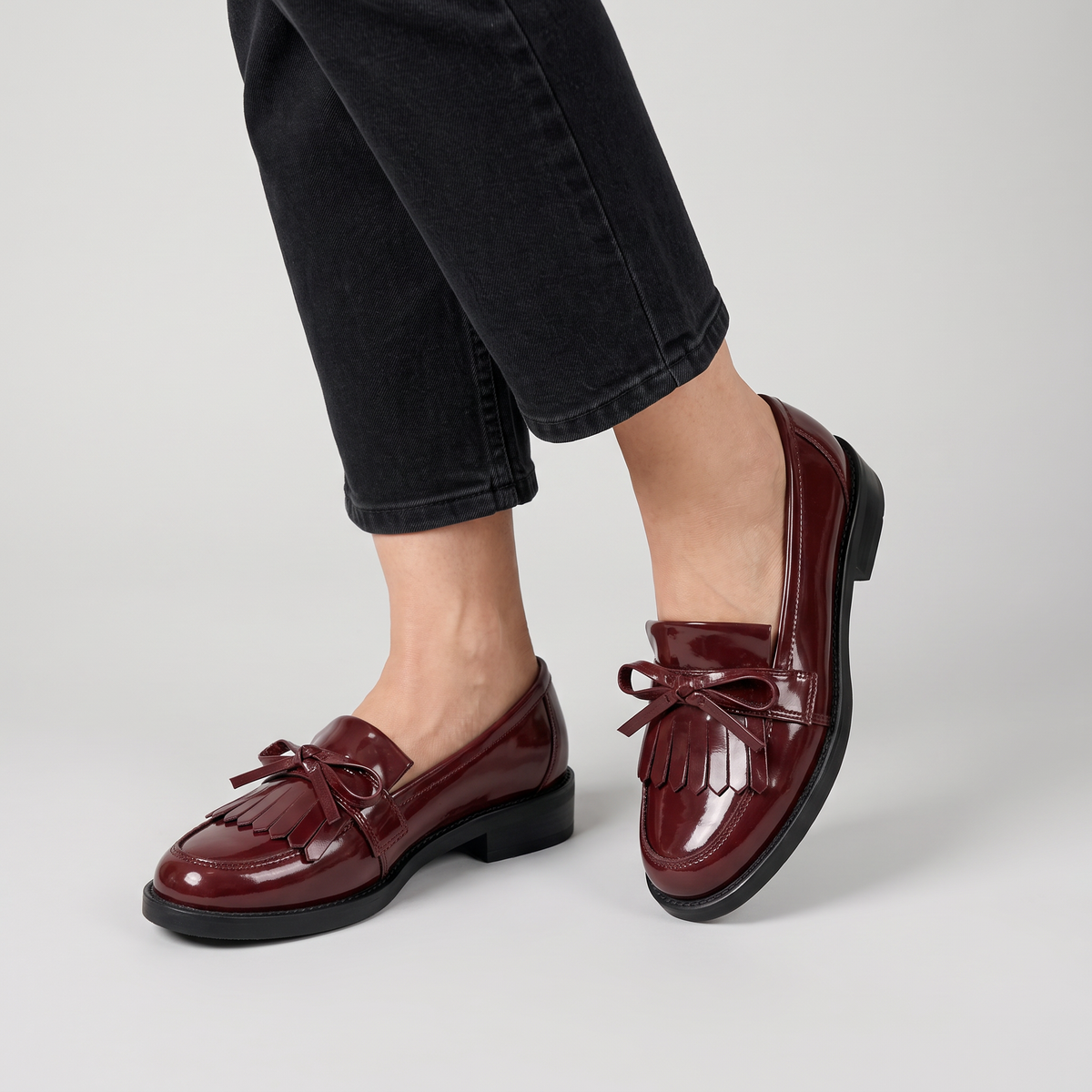 Cordelia glossy loafers with fringe and bow worn